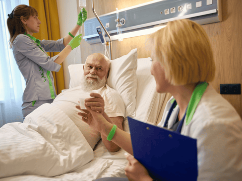 A caring doctor and nurse provide comfort and support to an elderly stroke survivor, illustrating the challenges and importance of managing post-stroke care like dysphagia.