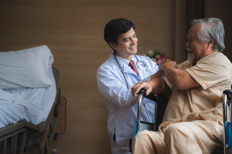 aregiver assisting a stroke survivor as he stands with a cane, showcasing daily mobility support