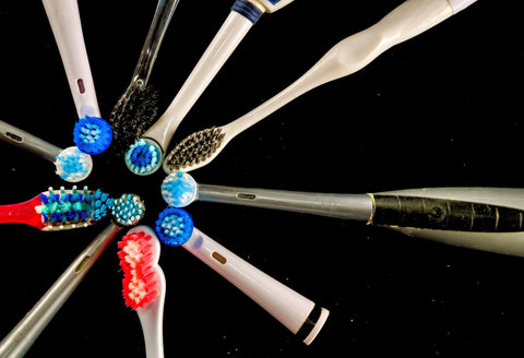 Various types of toothbrushes laid out, showing options for specialized oral care needs